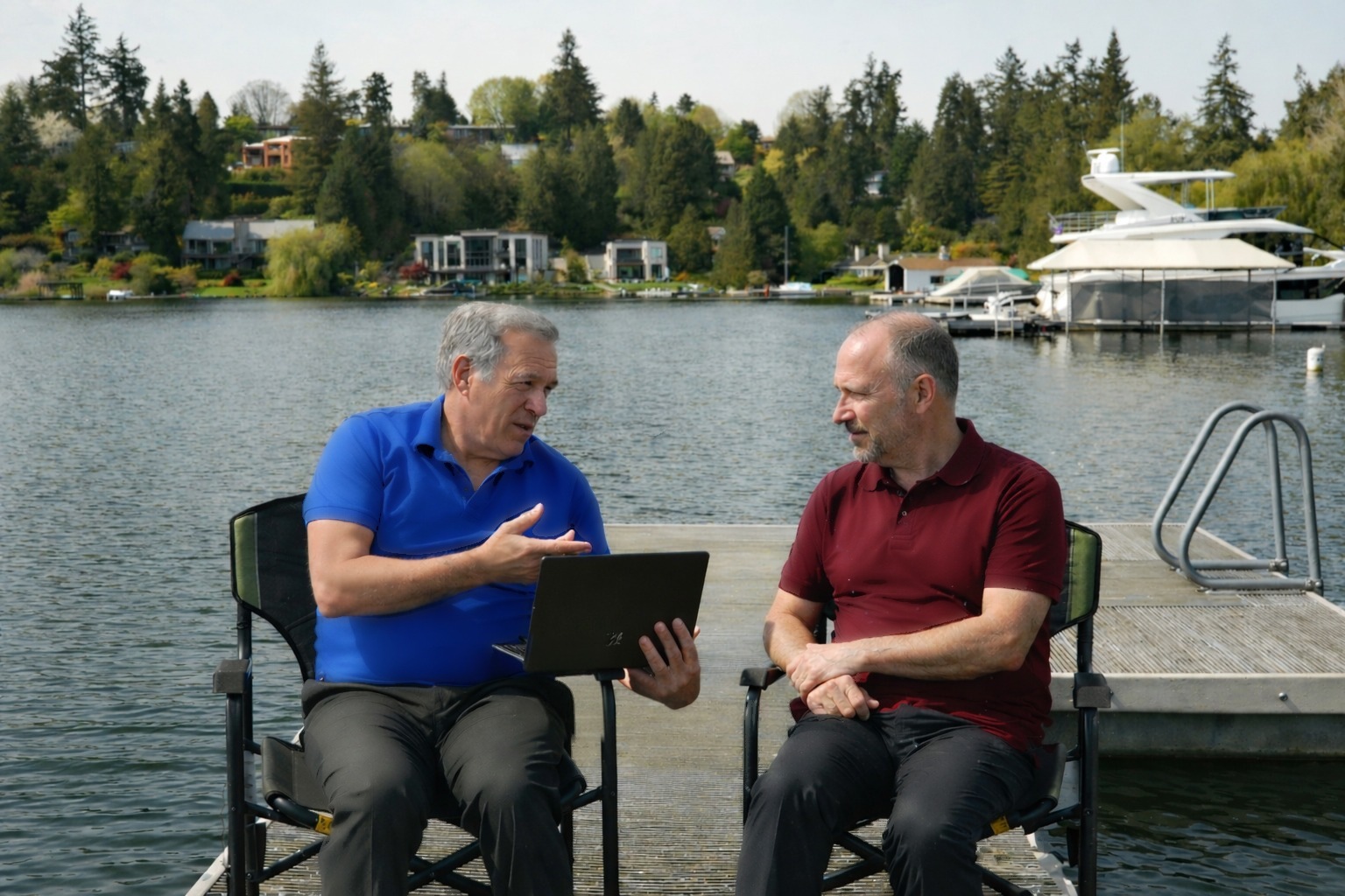 Steve talking through options with a client on a lakeside dock